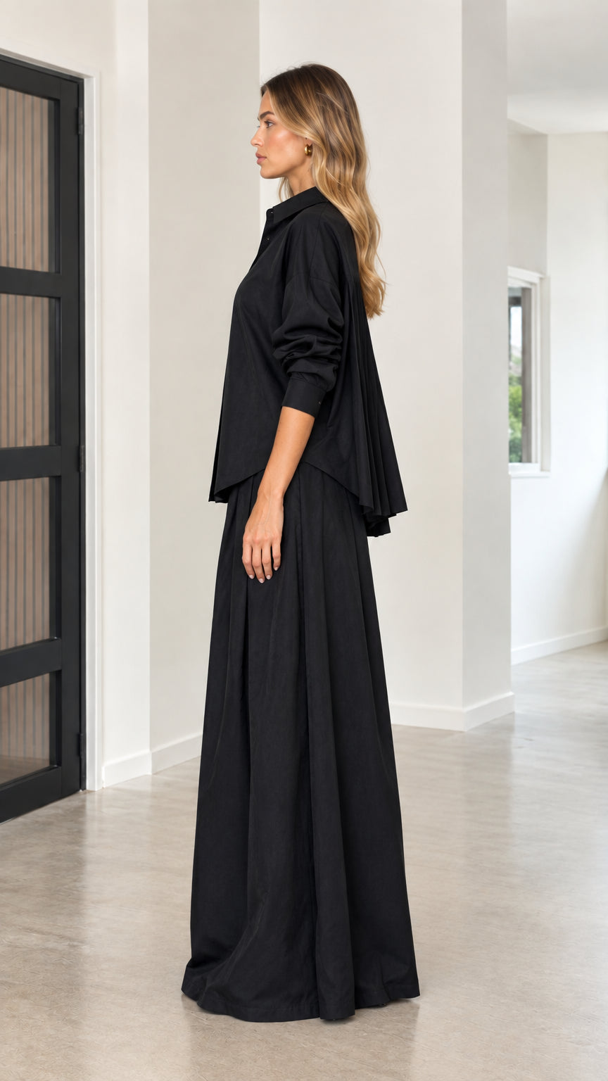 Side view of black button-down shirt and flowing palazzo trousers set