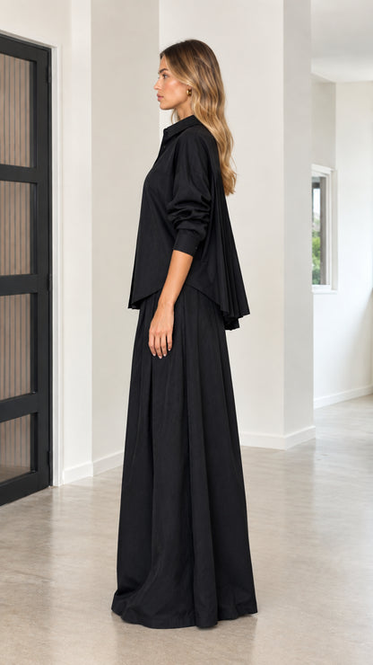 Side view of black button-down shirt and flowing palazzo trousers set