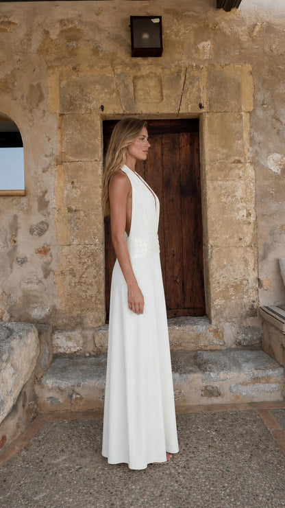 Side profile view of white maxi dress with open back