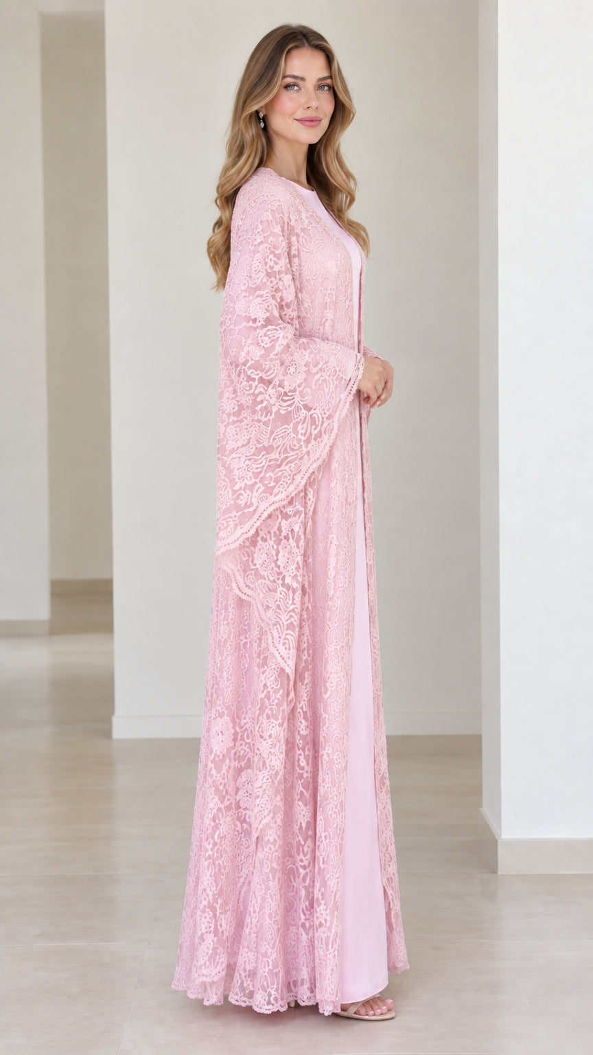 Side profile of model in light pink lace open-front duster over full-length inner dress