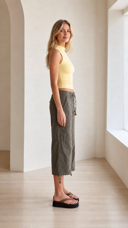 Side profile view of light yellow mock neck sleeveless tank top