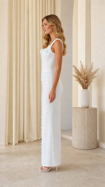 Side profile of model in white pearl embellished maxi dress