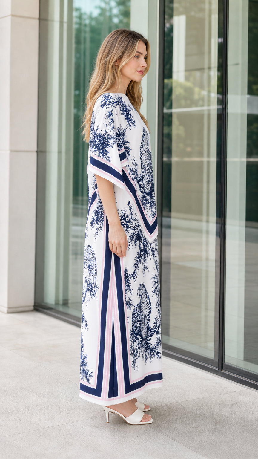 Side profile of woman wearing white leopard print kaftan dress
