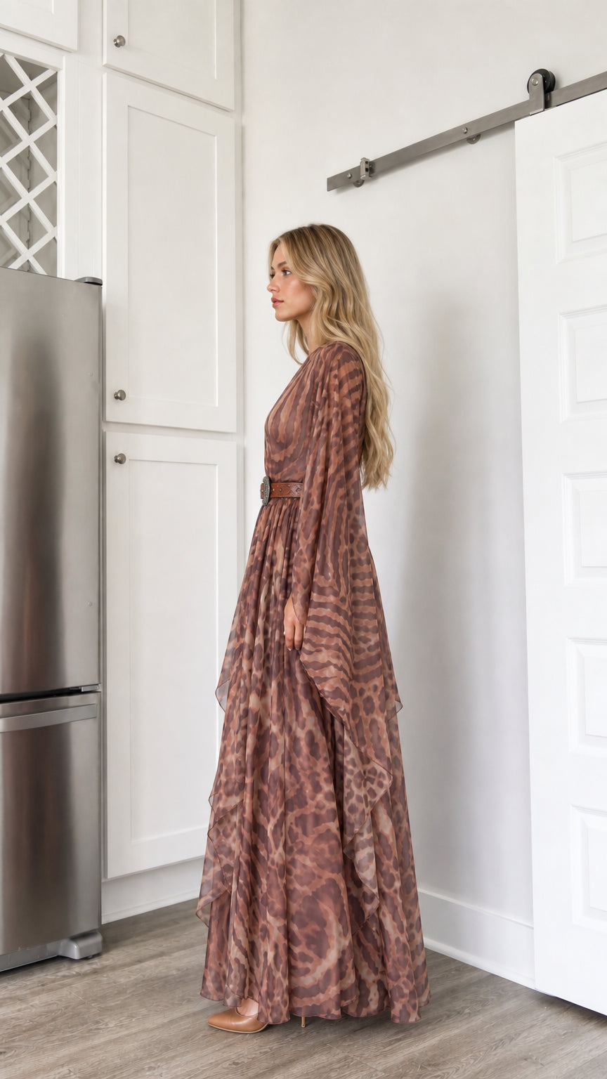 Side profile view of woman modeling the brown draped sleeve flowy maxi dress