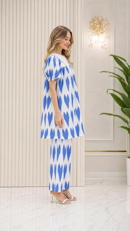 Side profile view of model wearing Bright Blue tunic set with statement collar
