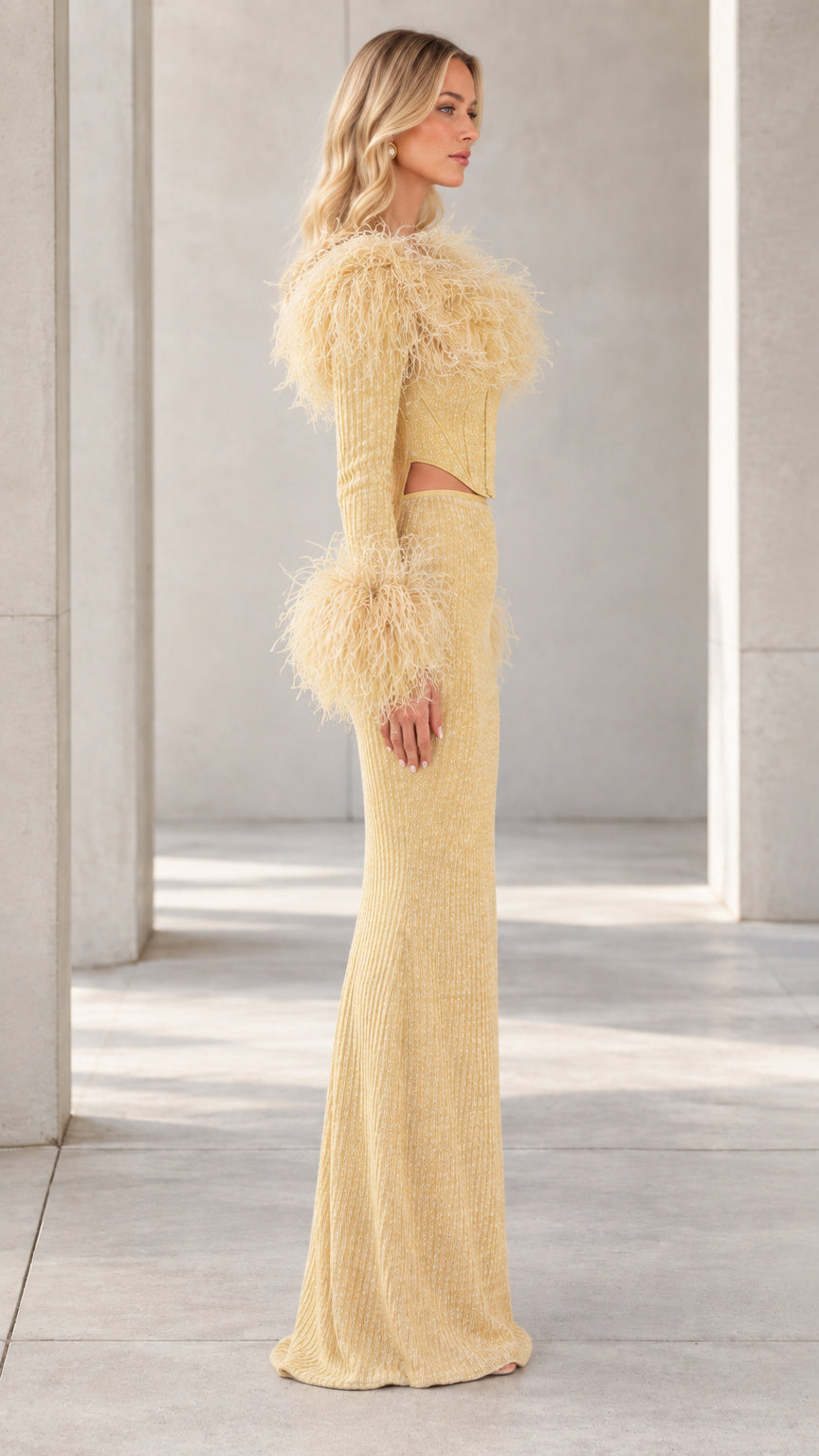 Side profile view of Champagne Gold long sleeve feather evening gown
