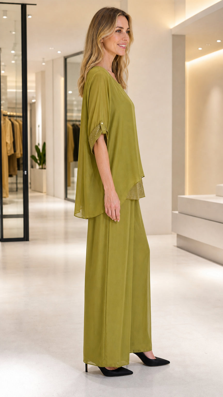 Side profile of olive green layered top and wide-leg chiffon pants