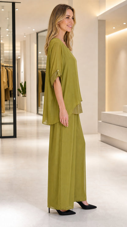 Side profile of olive green layered top and wide-leg chiffon pants