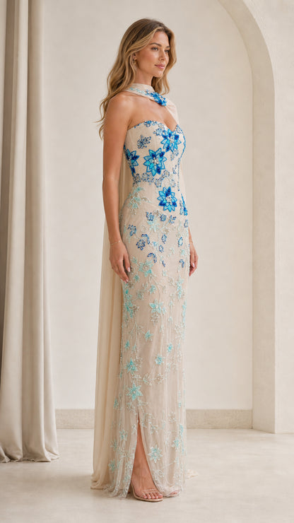 Side angle of model in champagne embellished strapless formal dress with drape
