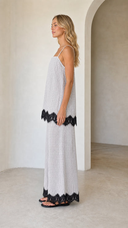 Model wearing white plaid two-piece set, side view
