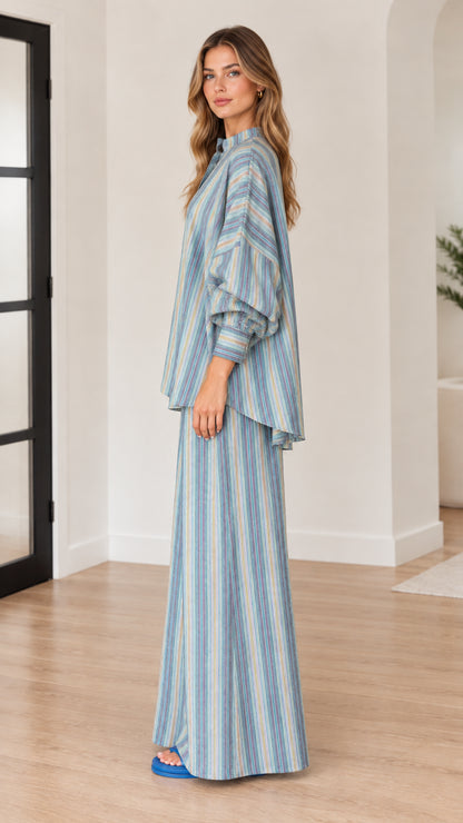 Side profile of woman wearing blue striped two-piece matching set