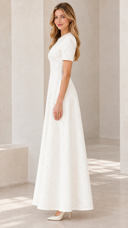 Side profile view of ivory pearl-embellished A-line formal evening dress