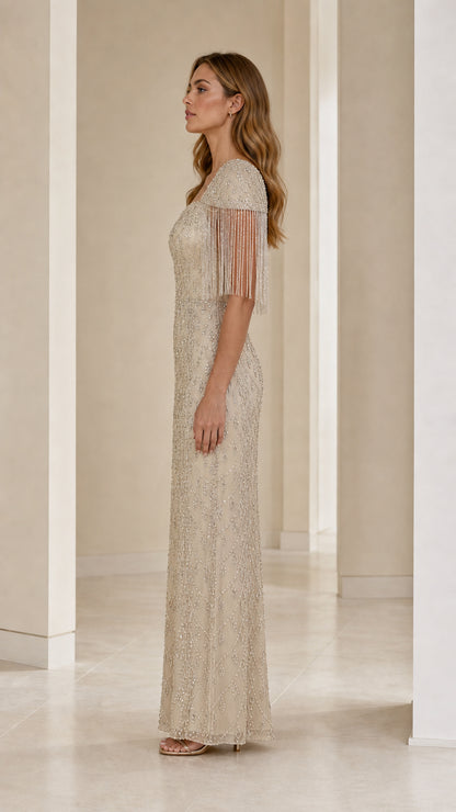 Side profile of champagne sequin column maxi dress showing beaded cap sleeve details