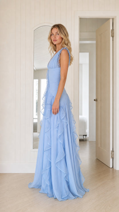 Side profile of woman in sky blue pleated ruffle formal evening gown