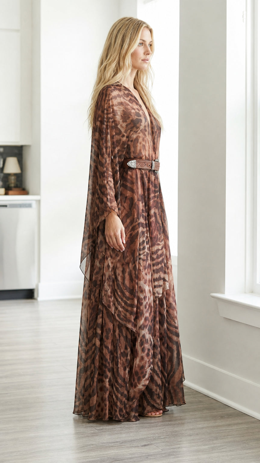 Side-angled view of brown flowing chiffon animal print maxi gown