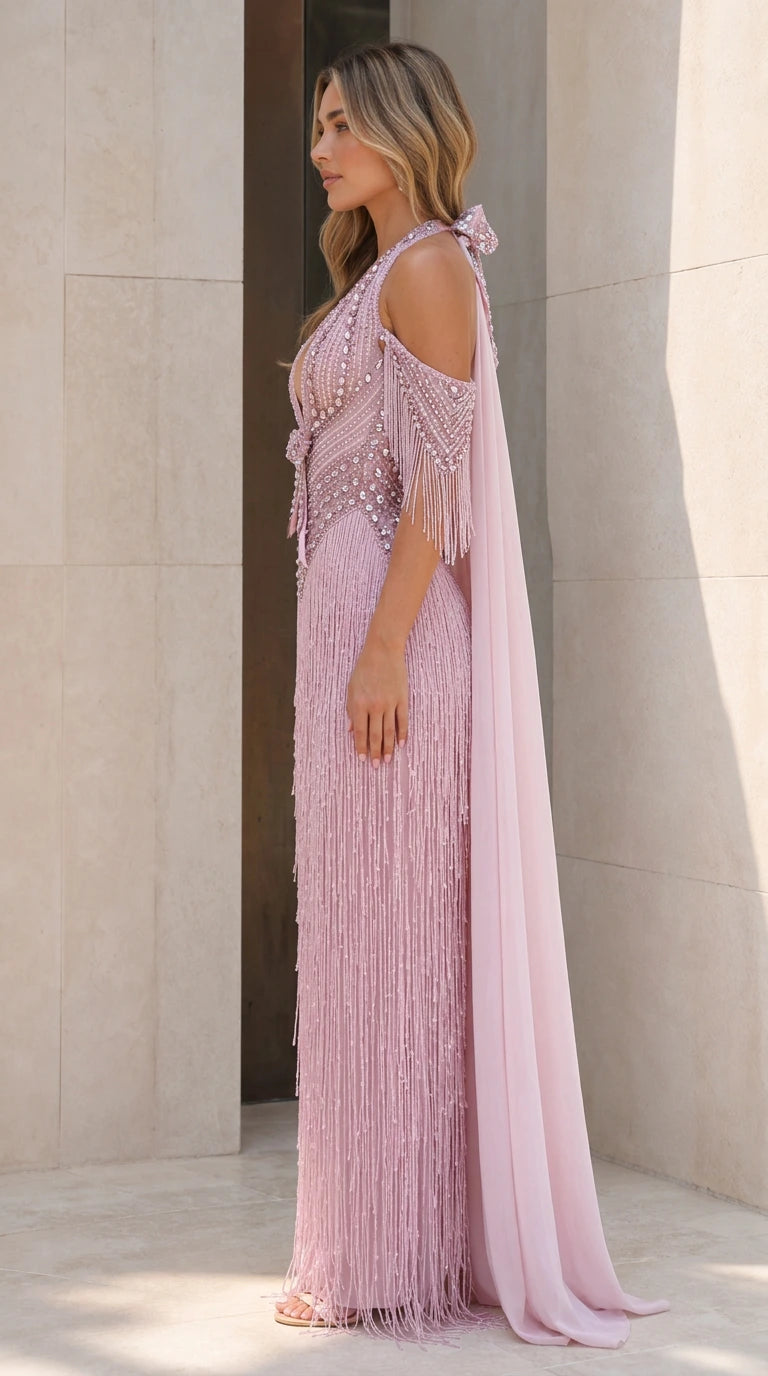 Side profile of dusty pink fringe evening gown with cape train