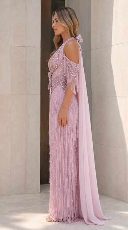 Side profile of dusty pink fringe evening gown with cape train