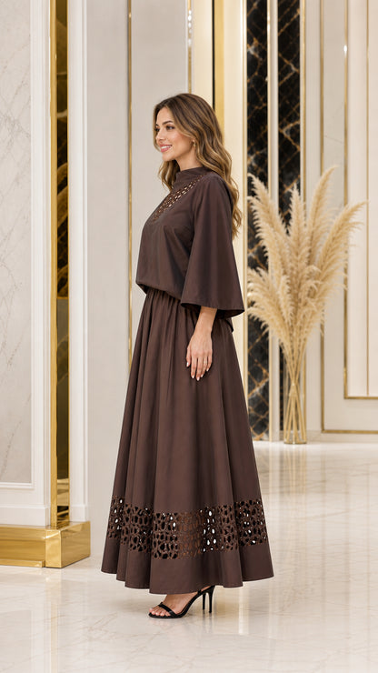 Side view of chocolate brown cutout top and long skirt set with wide sleeves