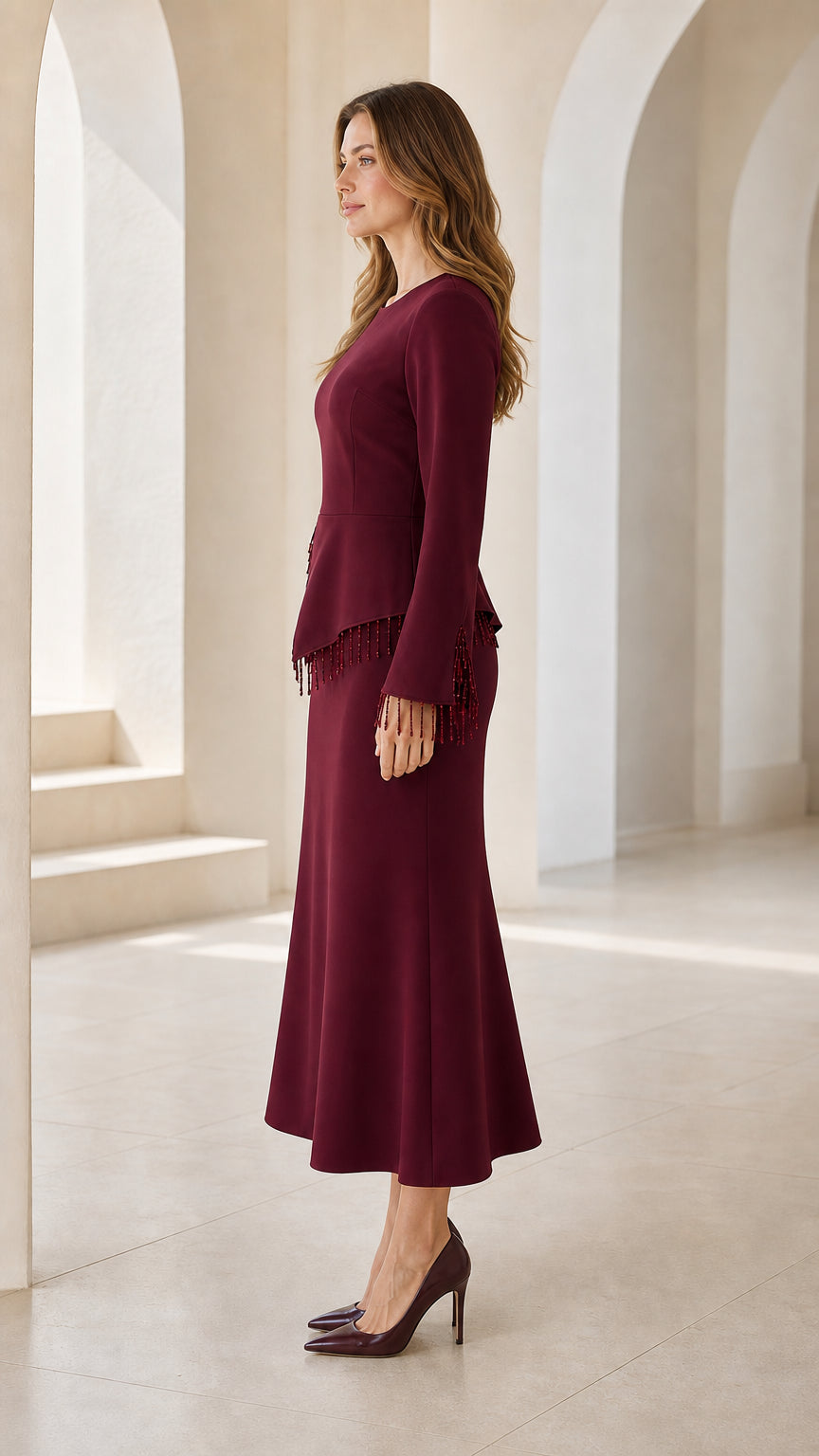 Side view of model wearing burgundy long sleeve peplum midi dress