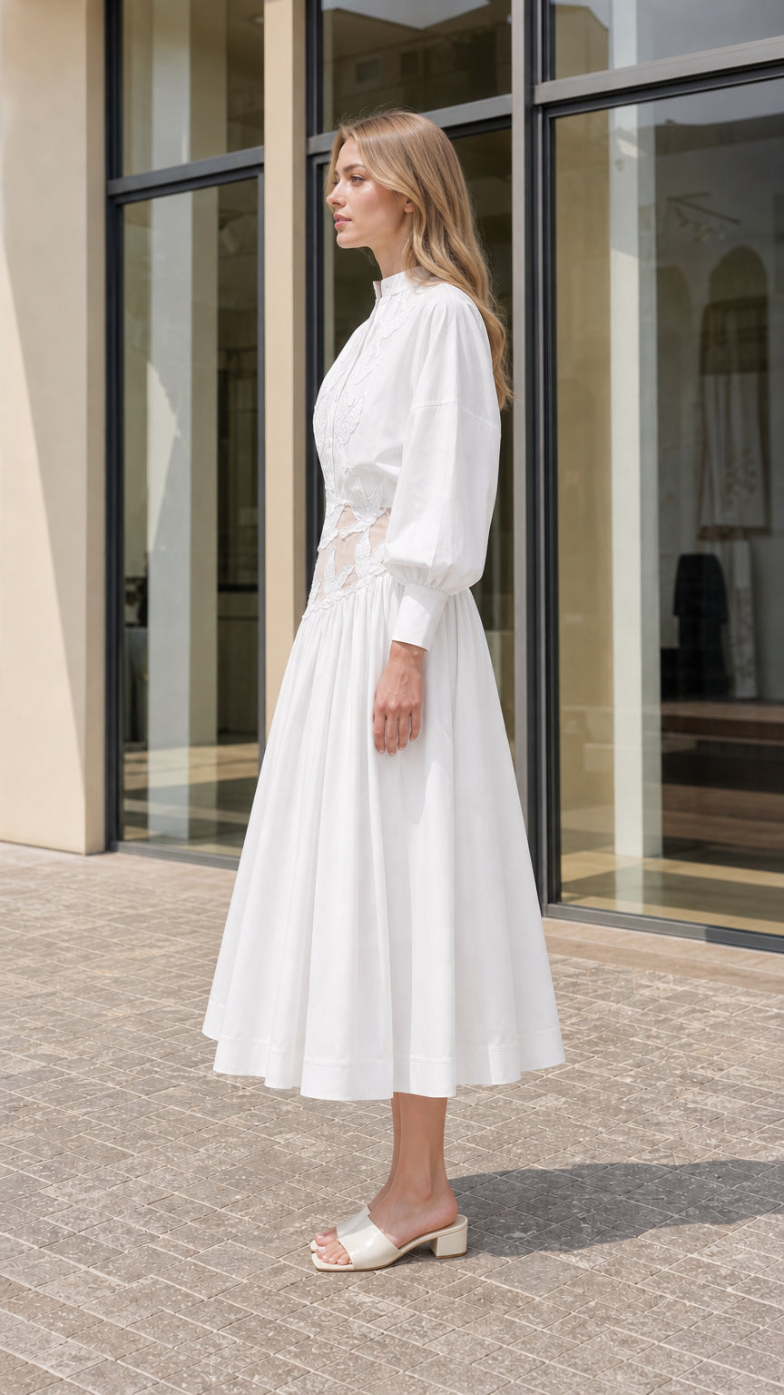 Side profile of model in white lantern sleeve midi dress with cutout waist