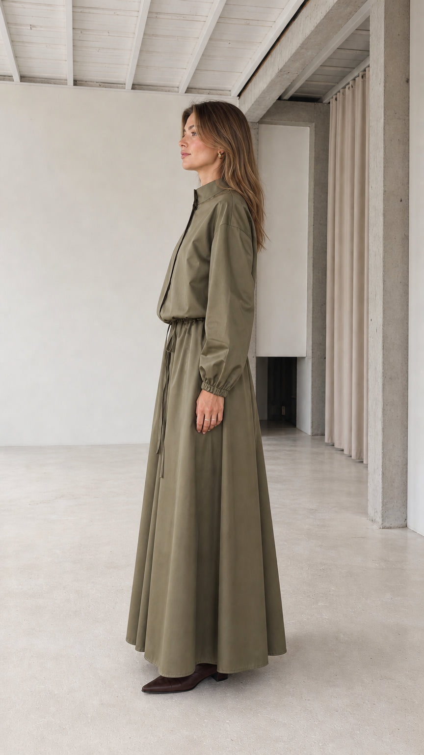 Side profile of woman wearing olive green long sleeve maxi dress