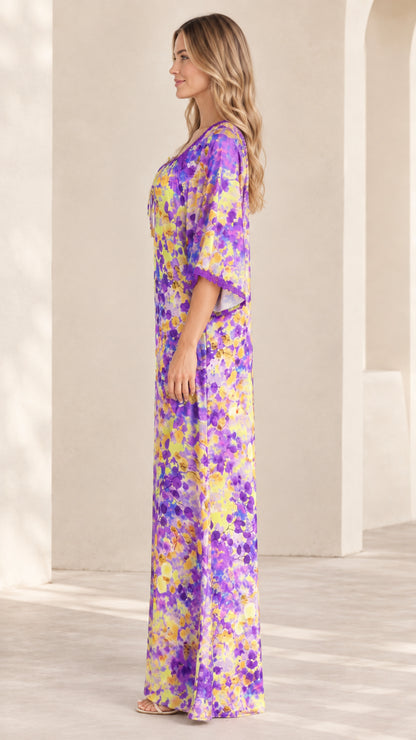 Side profile view of purple floral print kaftan maxi dress showing flowing relaxed drape
