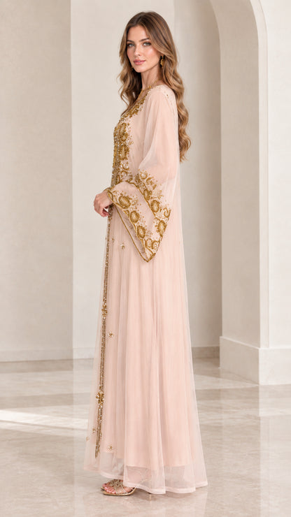 Side profile of woman in blush pink embellished long sleeve kaftan abaya