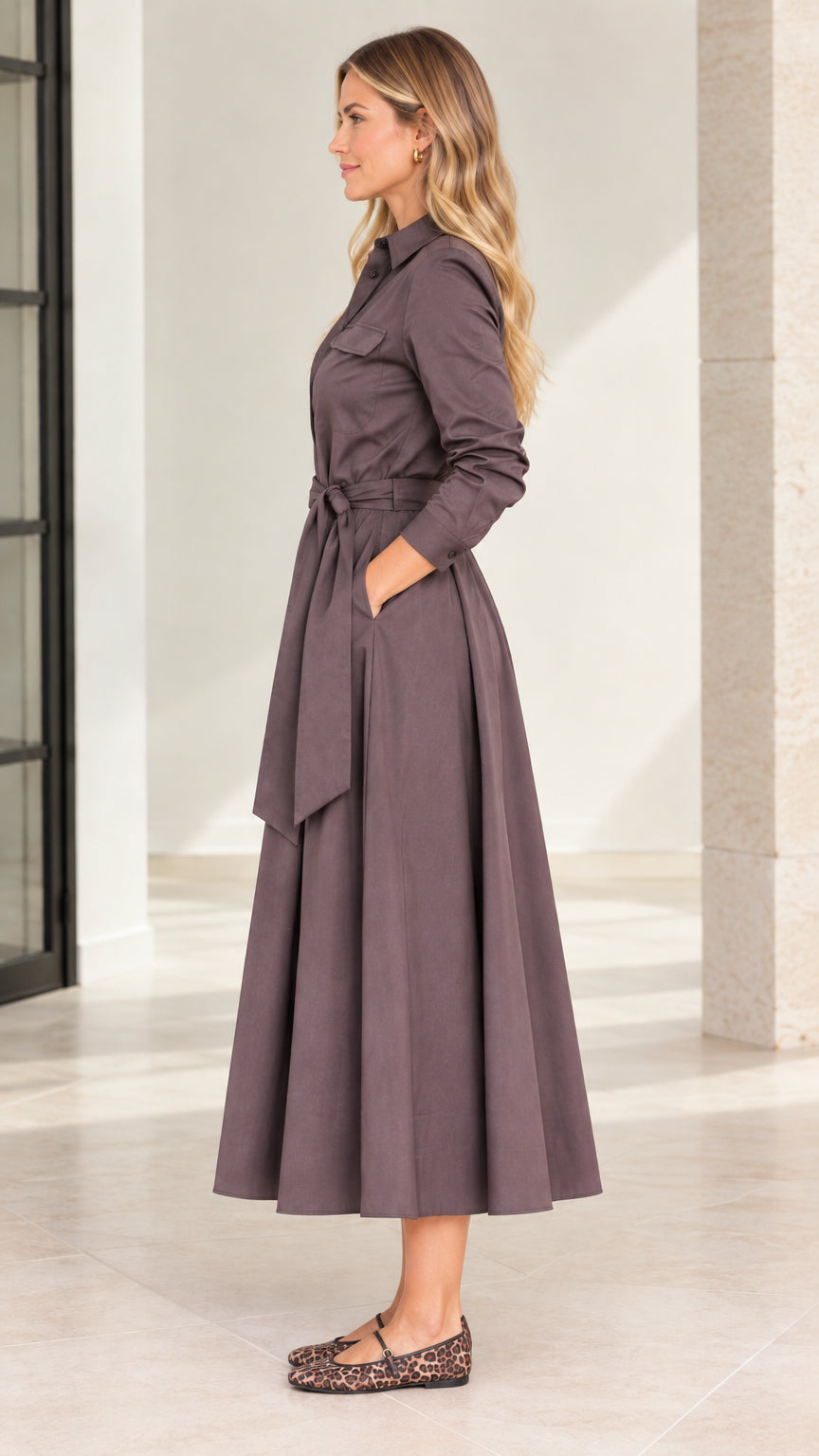 Side profile view of model wearing mocha brown belted midi shirt dress with pockets