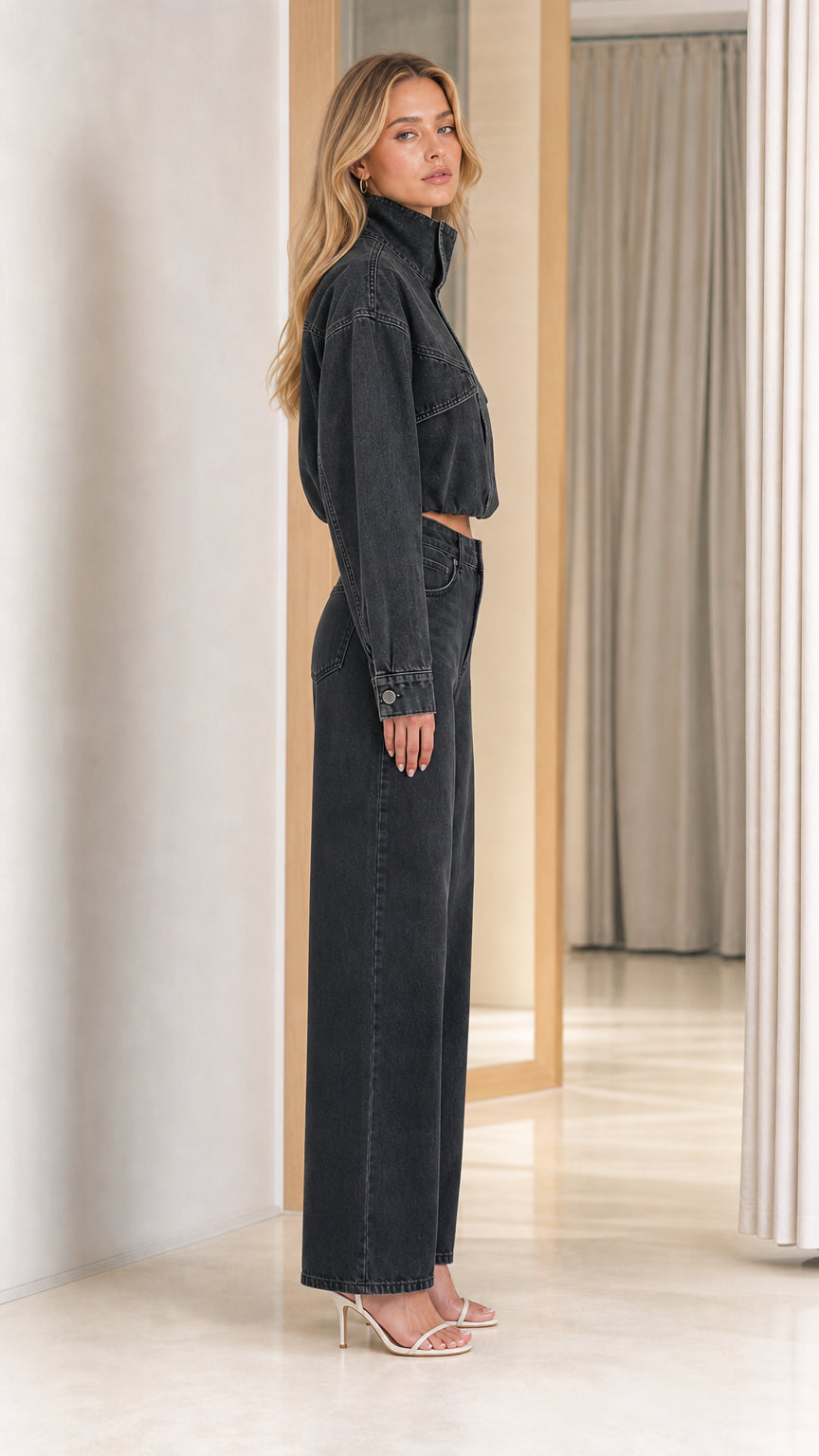 Side profile of washed black cropped denim utility set