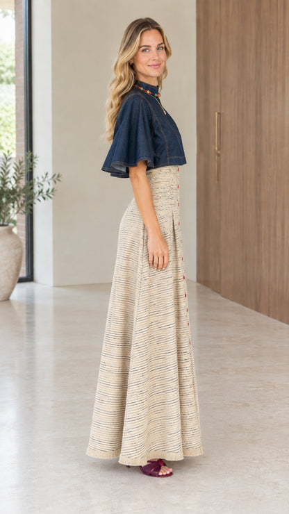 Side profile view of beige tweed maxi dress showing high-rise waistline and flutter sleeves