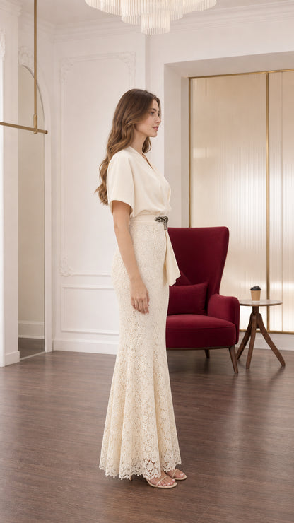 Side profile view of cream lace mermaid formal gown showing sleek silhouette