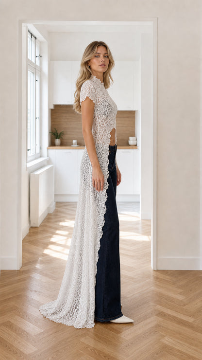 Side profile view of floor-length white lace duster with high front open slit
