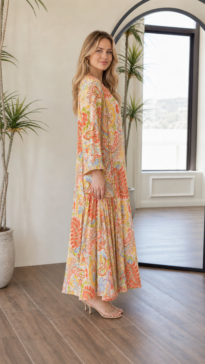Side profile view of woman wearing bohemian yellow multi tiered maxi dress