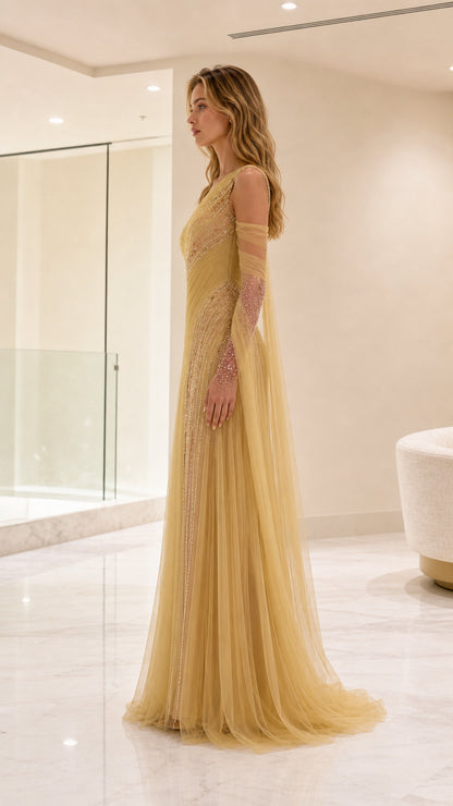 Side profile view of gold one-shoulder formal evening dress showing flowing silhouette