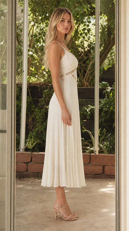 Side profile of model in white midi dress