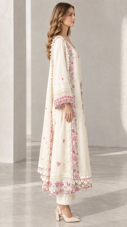 Side profile view of model wearing Cream floral embroidered tunic and matching trousers