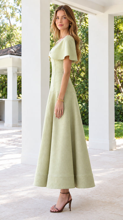 Side profile view of sage green cape collar flared midi dress