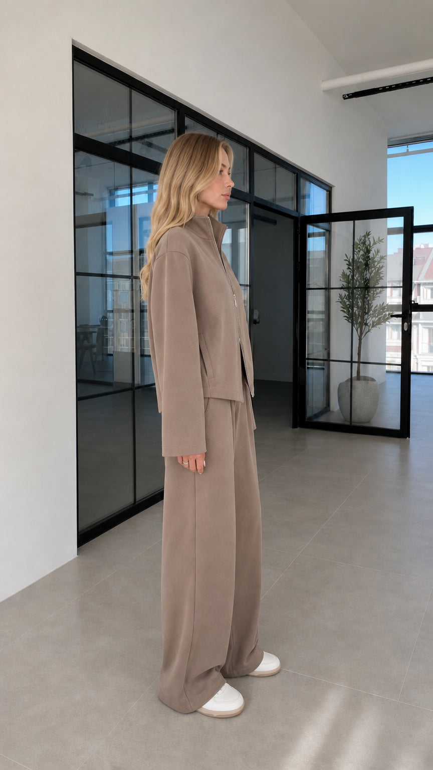 Woman wearing taupe lounge set side profile