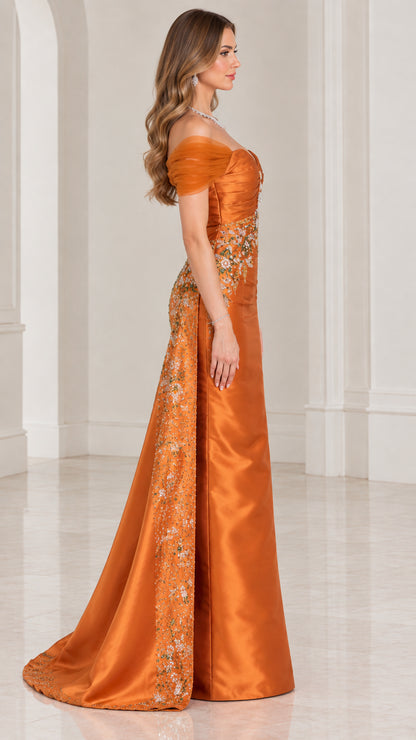 Side profile of rust orange formal gown showing embellished overskirt drape
