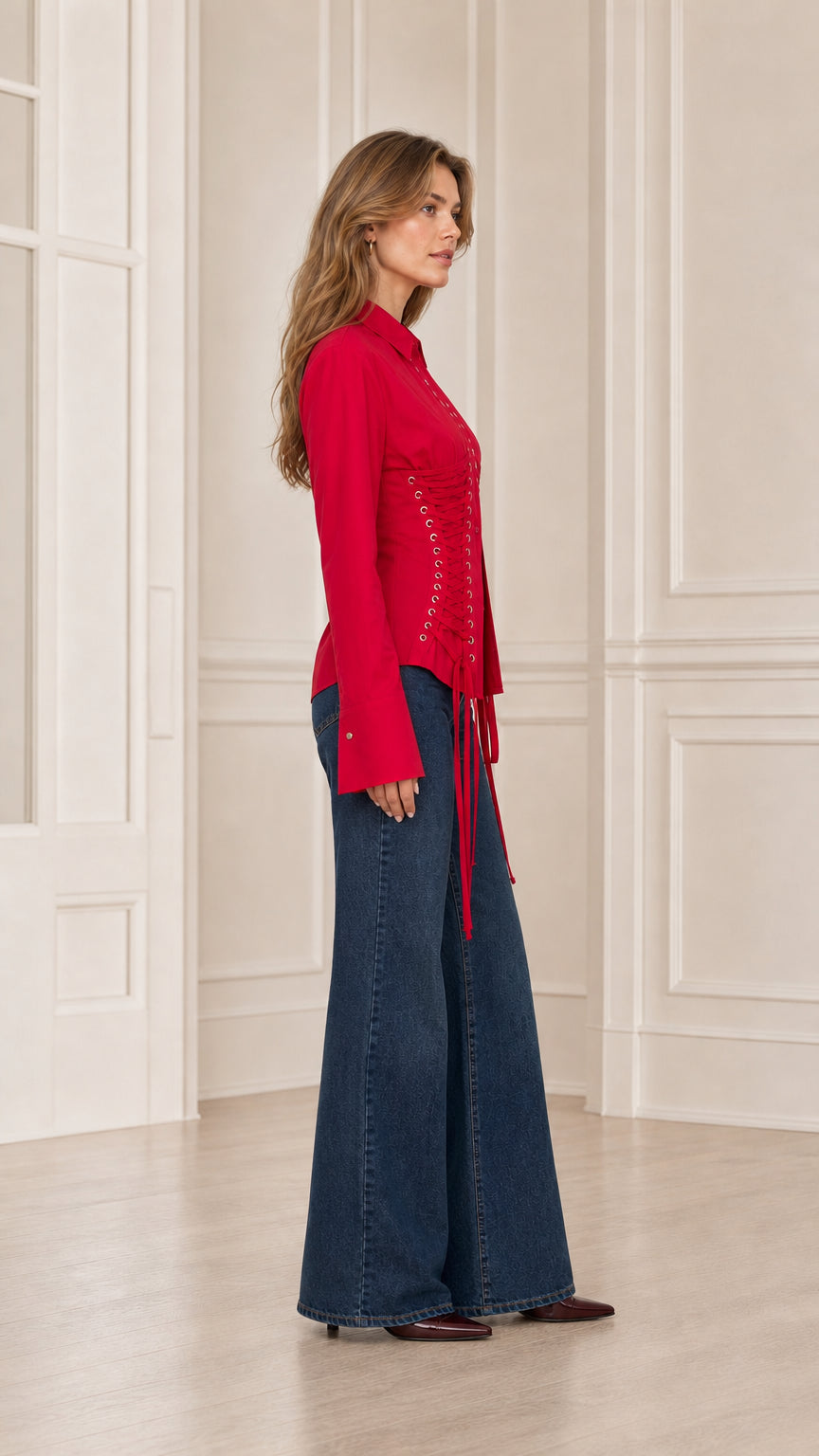 Side profile view of red long sleeve corset shirt with eyelet ties