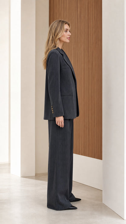 Side profile of model wearing charcoal grey tailored pinstripe suit set
