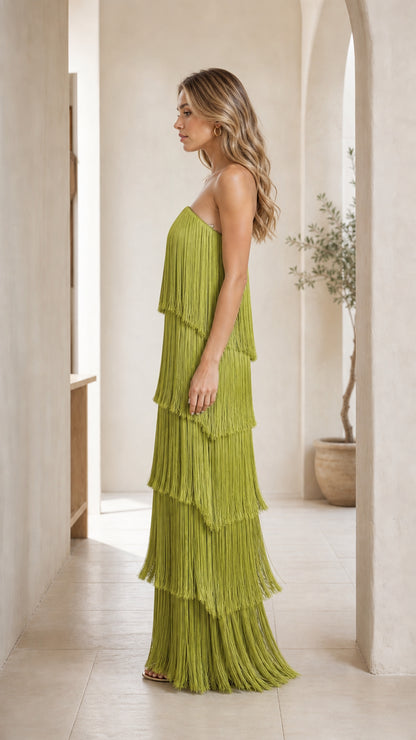 Side profile view of woman in olive green fringe maxi dress