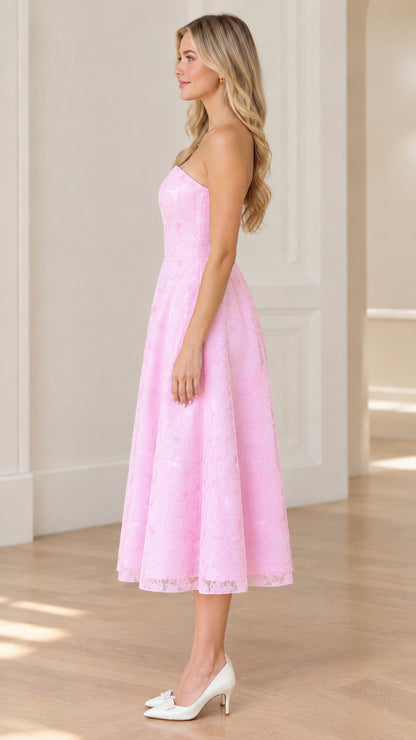 Side profile of woman in strapless pink floral lace midi dress