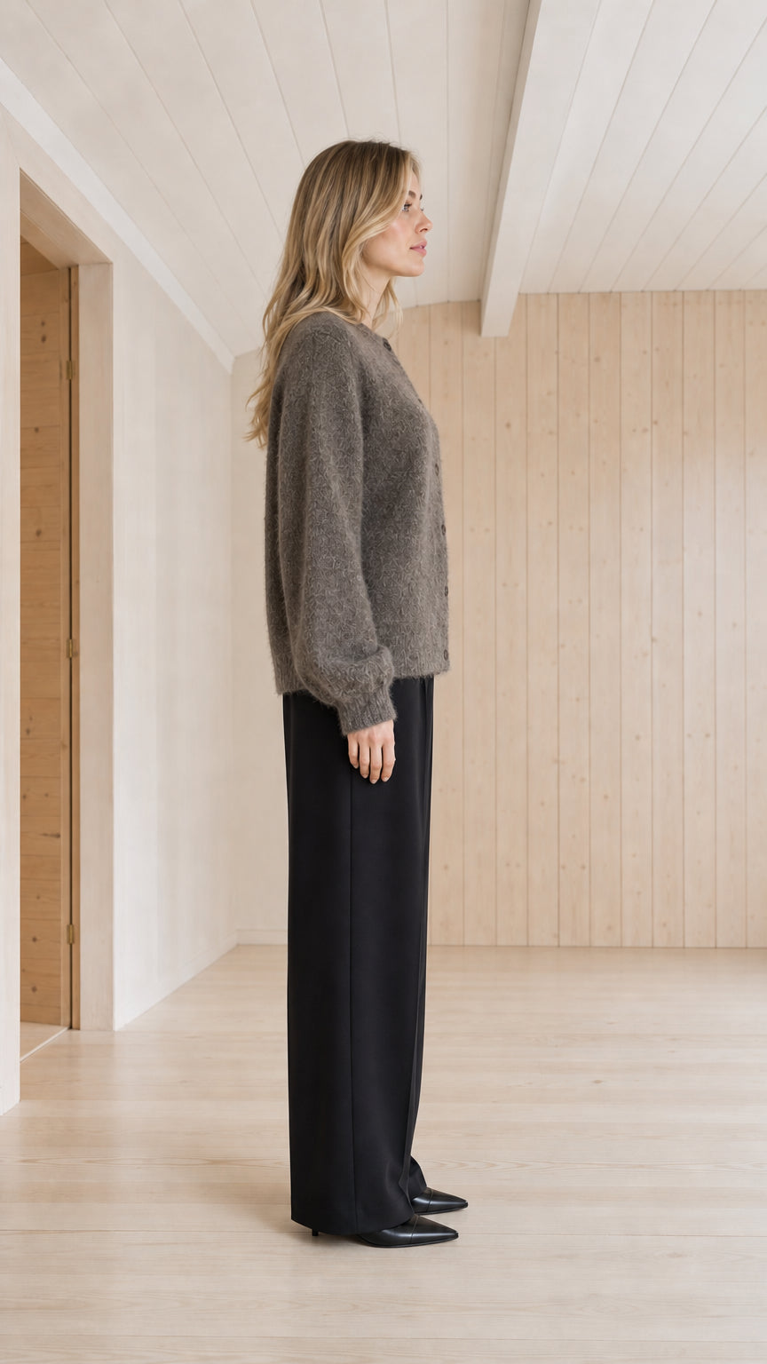 Side profile view of charcoal grey fuzzy button-down cardigan sweater