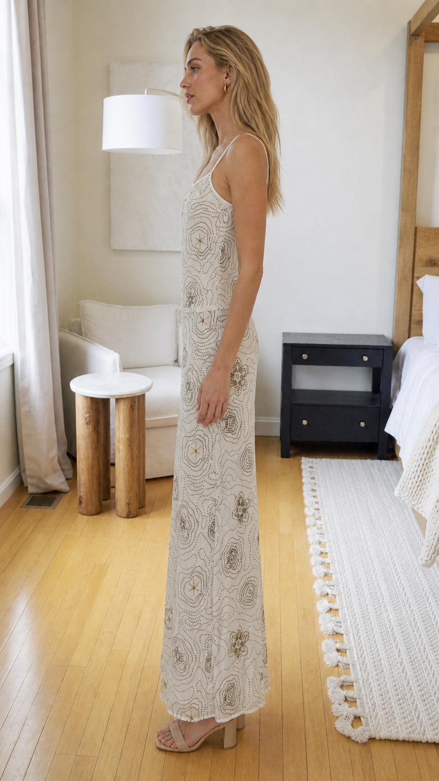 Side profile of cream beaded maxi dress