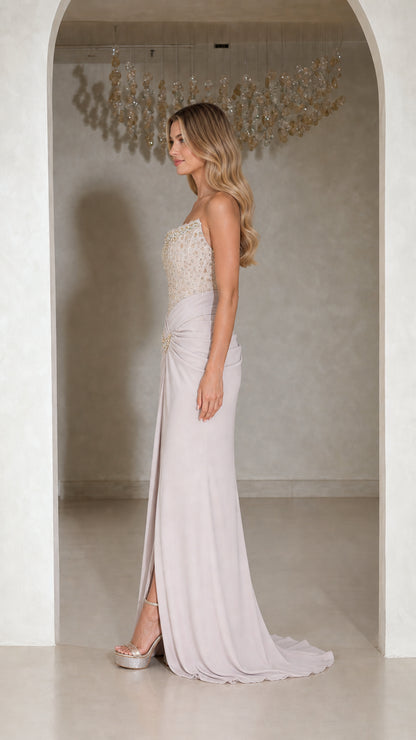 Side profile of strapless silver lilac beaded evening dress showing floor length drape