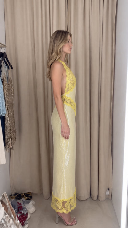 Side view of model in Pale Yellow sequin halter dress showing silhouette and fit