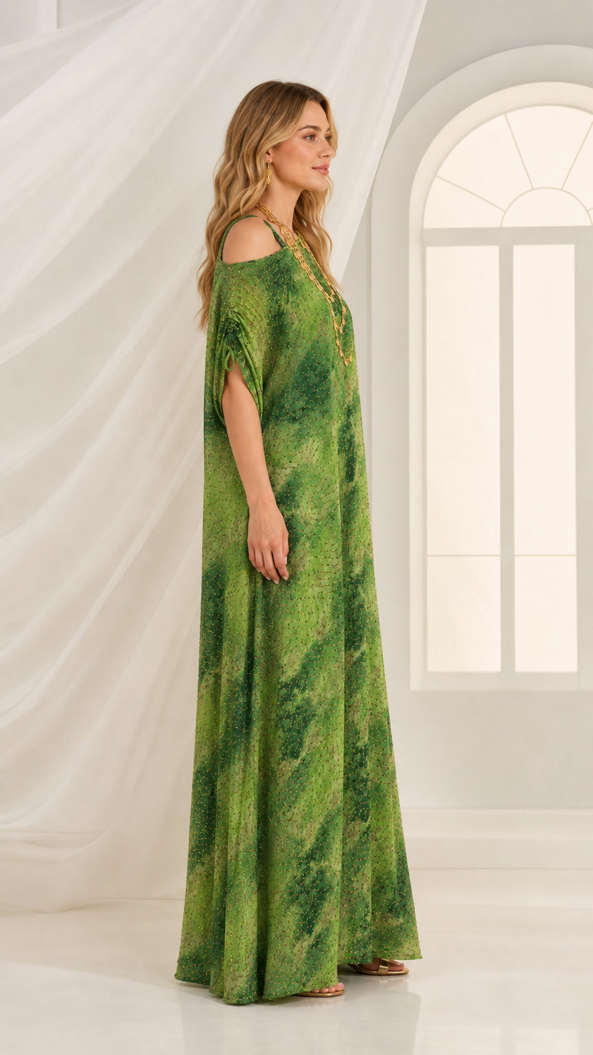 Side profile of woman wearing green embellished kaftan dress with drawstring sleeve