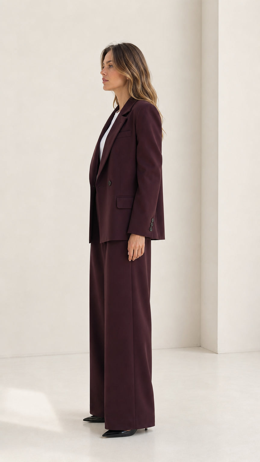 Side profile of woman in burgundy wide-leg pant suit set