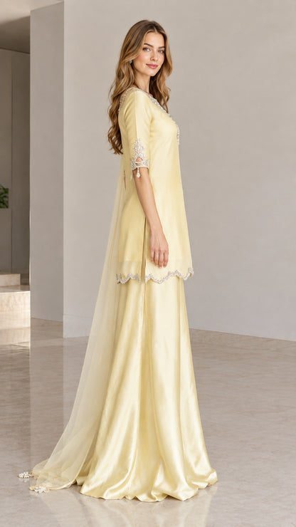 Side angle view of woman wearing lemon yellow festive 3-piece suit set